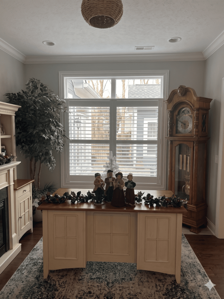InStyle Blinds IN - a cozy office area with a grandfather clock has custom shutters on the windows. 
