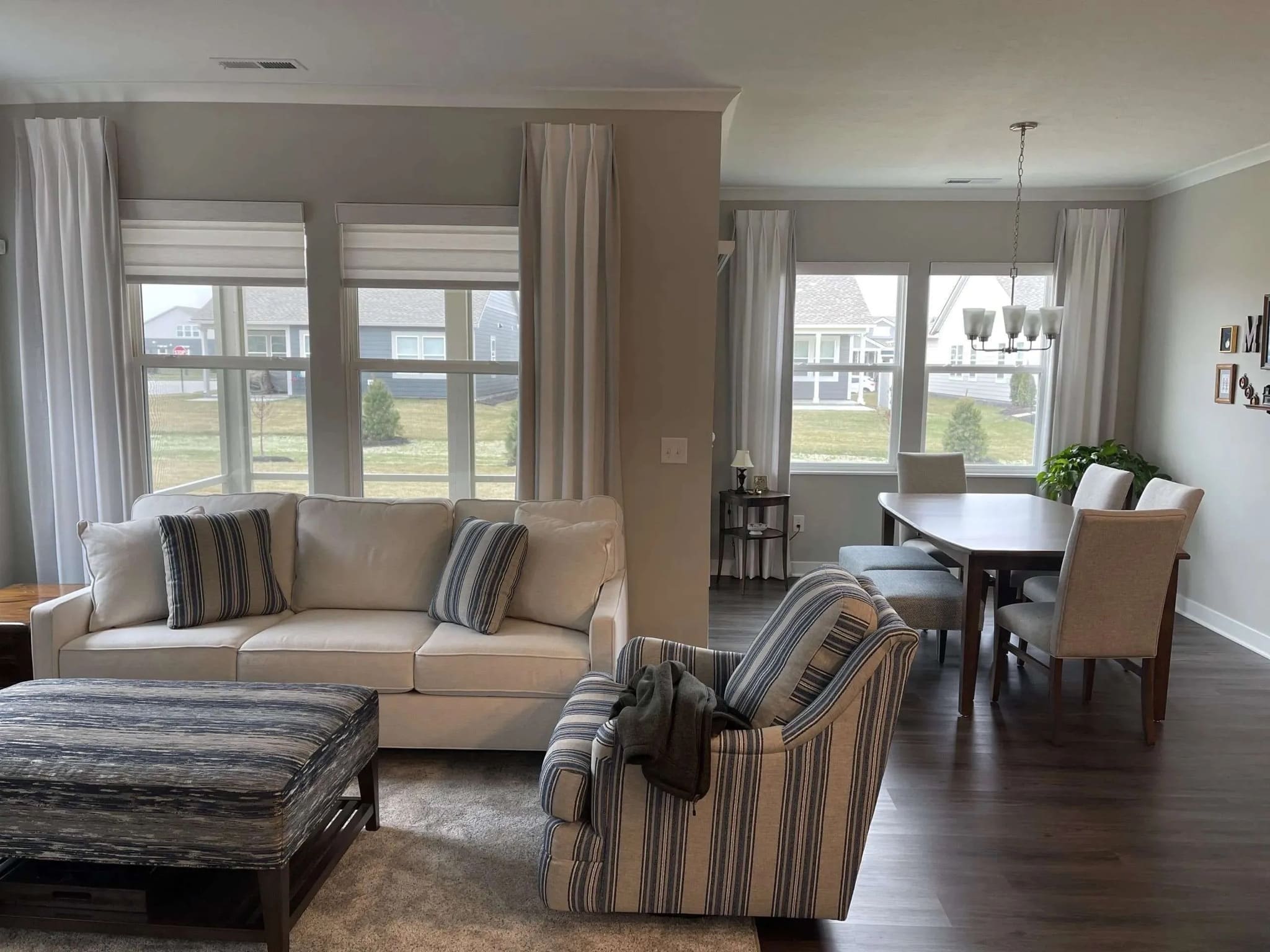 InStyle Blinds IN - a bright living room has a cozy feel with the drapery panels on the windows.