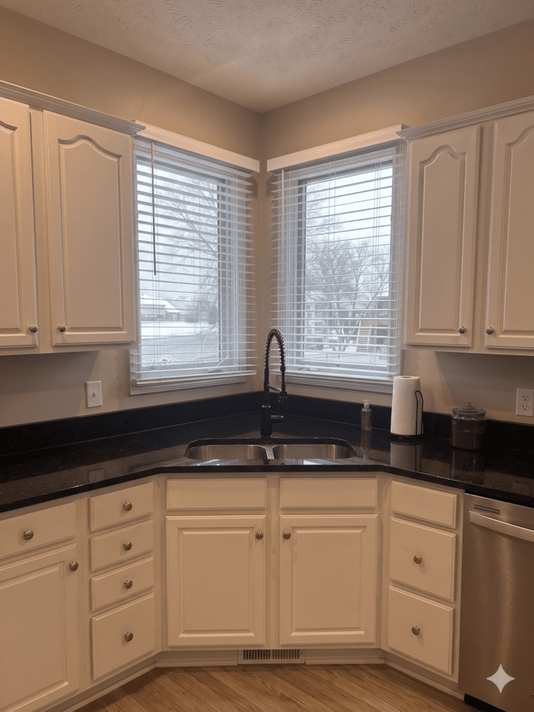 InStyle Blinds Indiana - A kitchen with black marble counter and window blinds on the windows. 